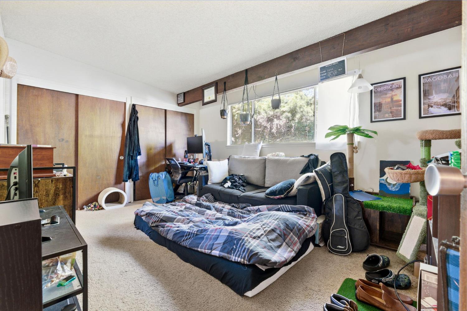 916 Drake Drive Davis, CA 95616 - Photo 17 of 19 a bedroom with a bed a couch and a large window