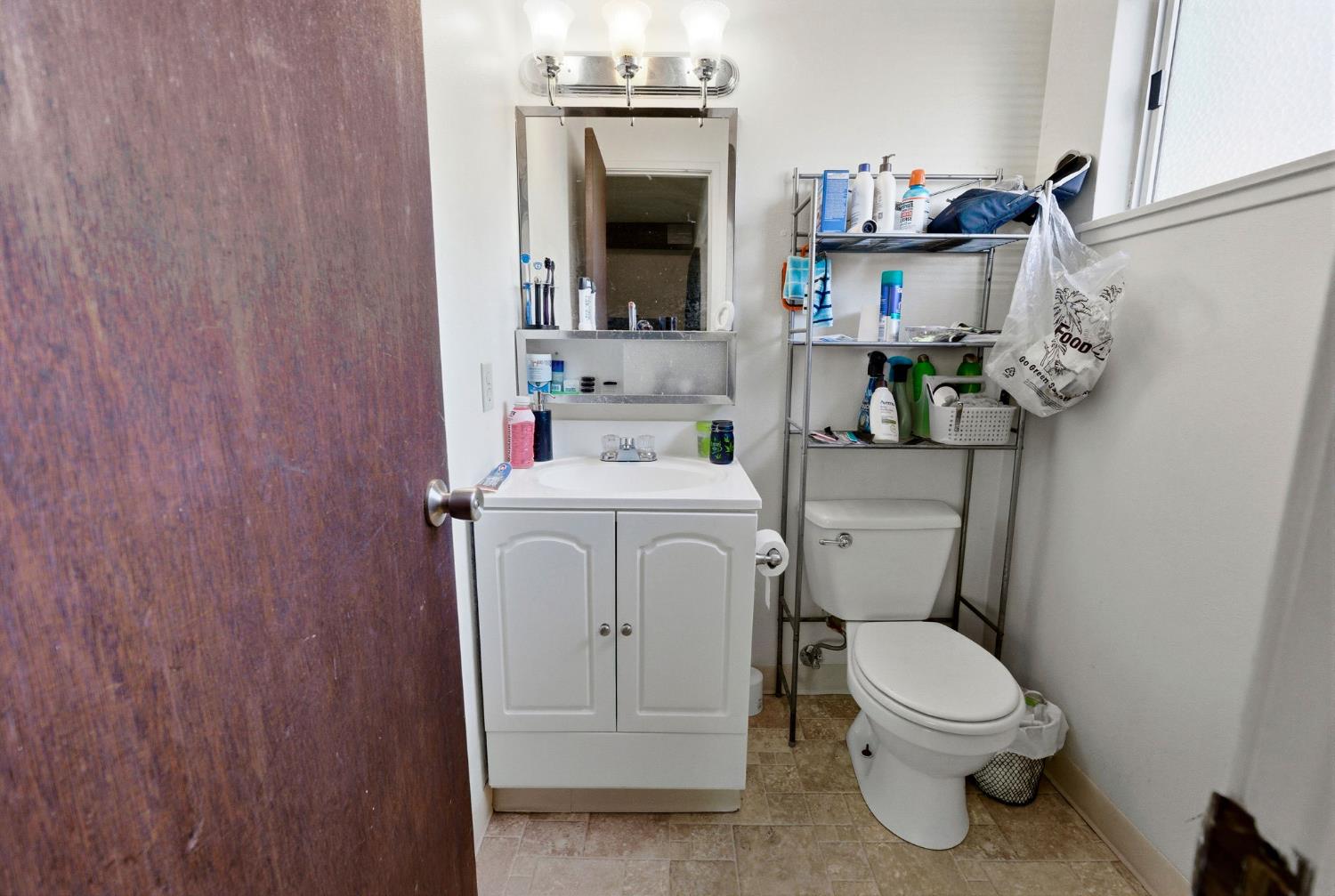 916 Drake Drive Davis, CA 95616 - Photo 18 of 19 a bathroom with a toilet sink and mirror