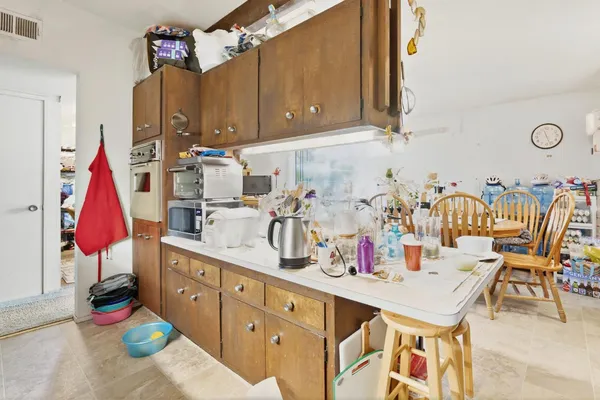 a kitchen with stainless steel appliances kitchen island granite countertop a sink and cabinets