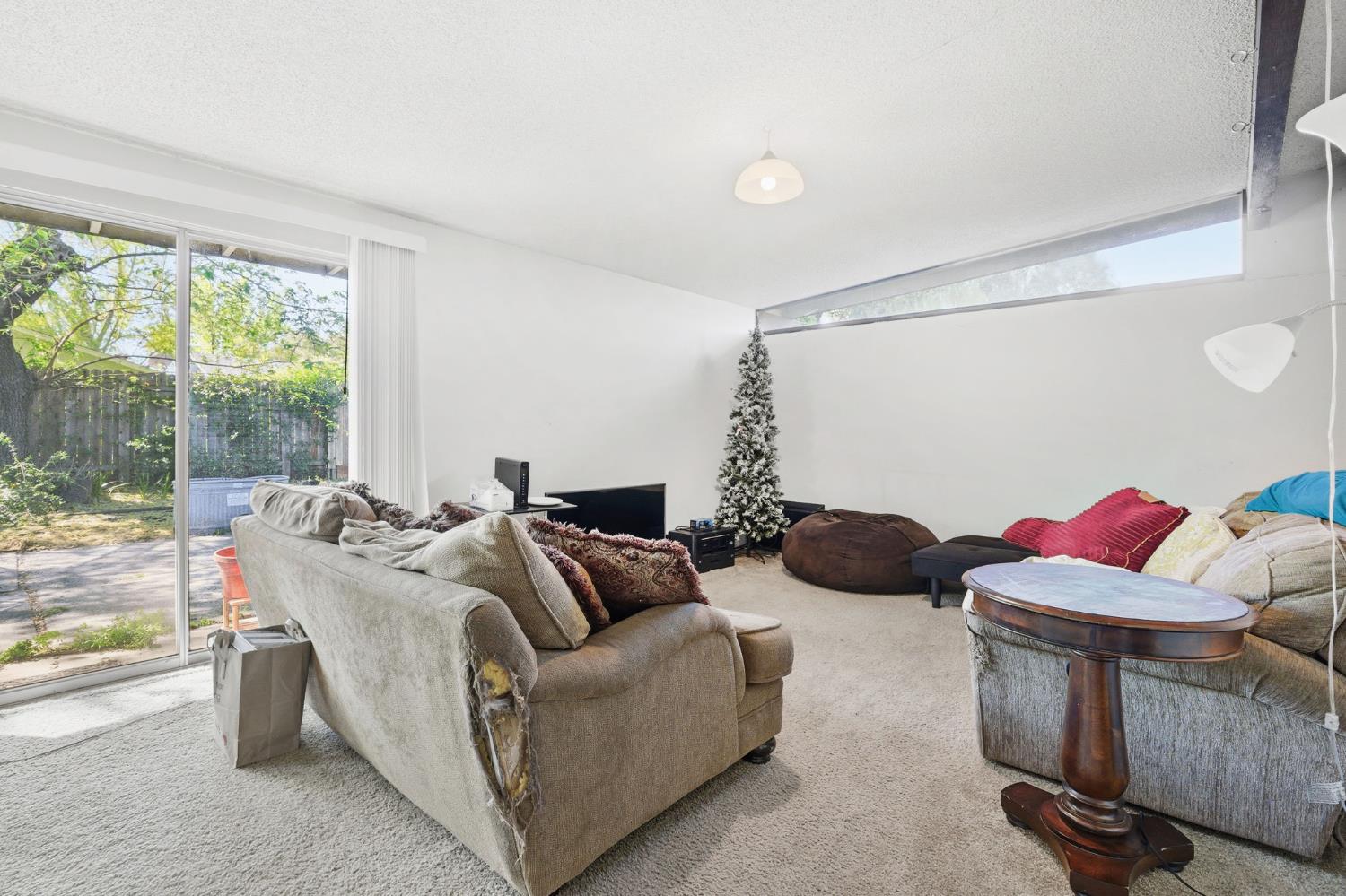916 Drake Drive Davis, CA 95616 - Photo 9 of 19 a living room with furniture and a floor to ceiling window
