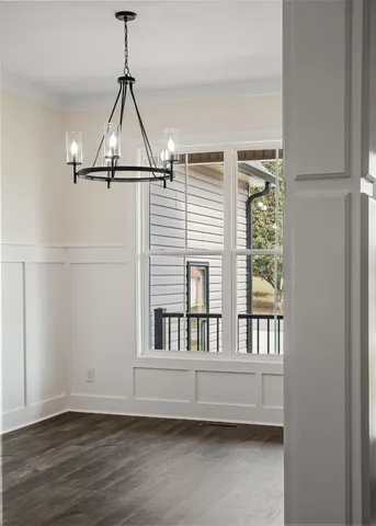 a view of a room with a window and wooden floor