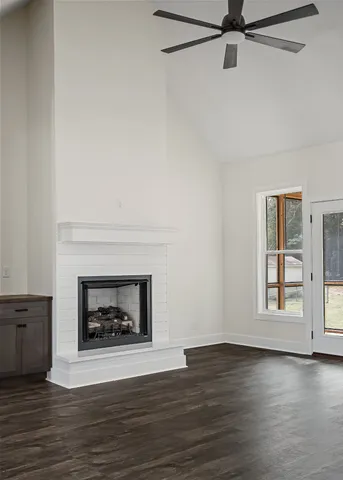 a living room with a fireplace with wooden floor