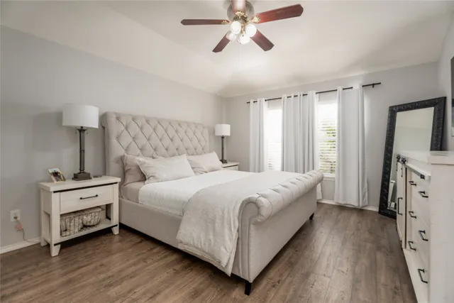 a bedroom with a bed and a flat tv screen on dresser