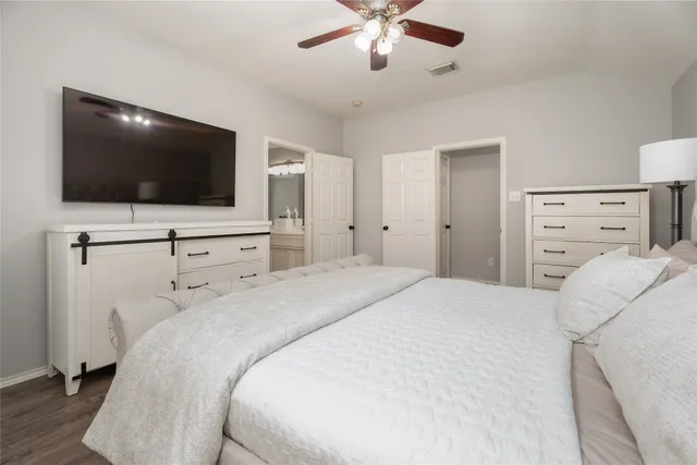 a bedroom with a bed and a flat screen tv