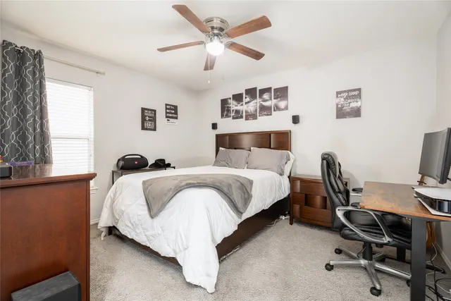 a bed room with a bed and a desk