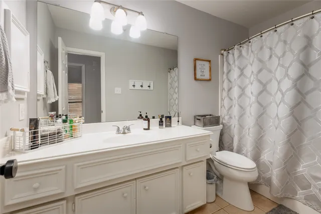a view of bathroom with a toilet sink and mirror