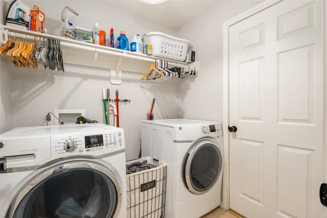 a view of storage and utility room with washer and dryer