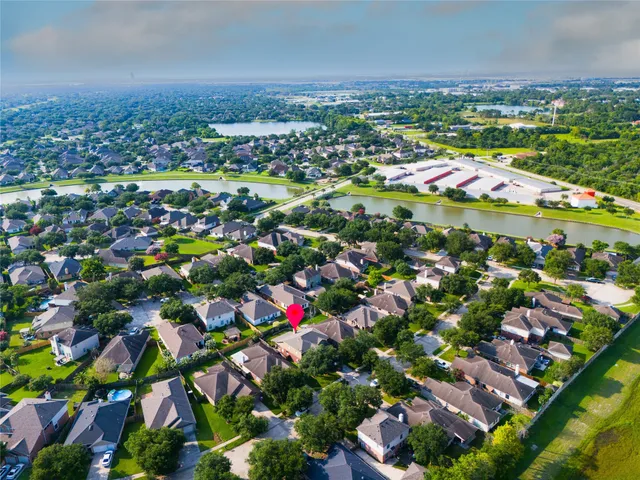 an aerial view of residential houses with outdoor space and swimming pool