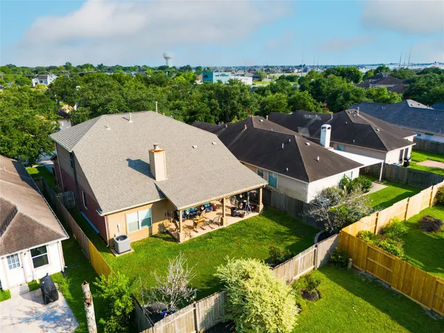 an aerial view of a house with swimming pool garden and outdoor seating
