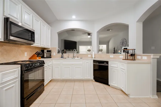 a kitchen with a sink stove and microwave