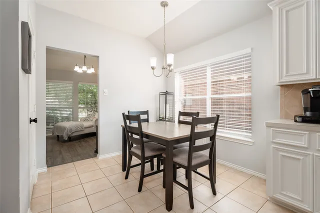 a view of a dining room with furniture and a window