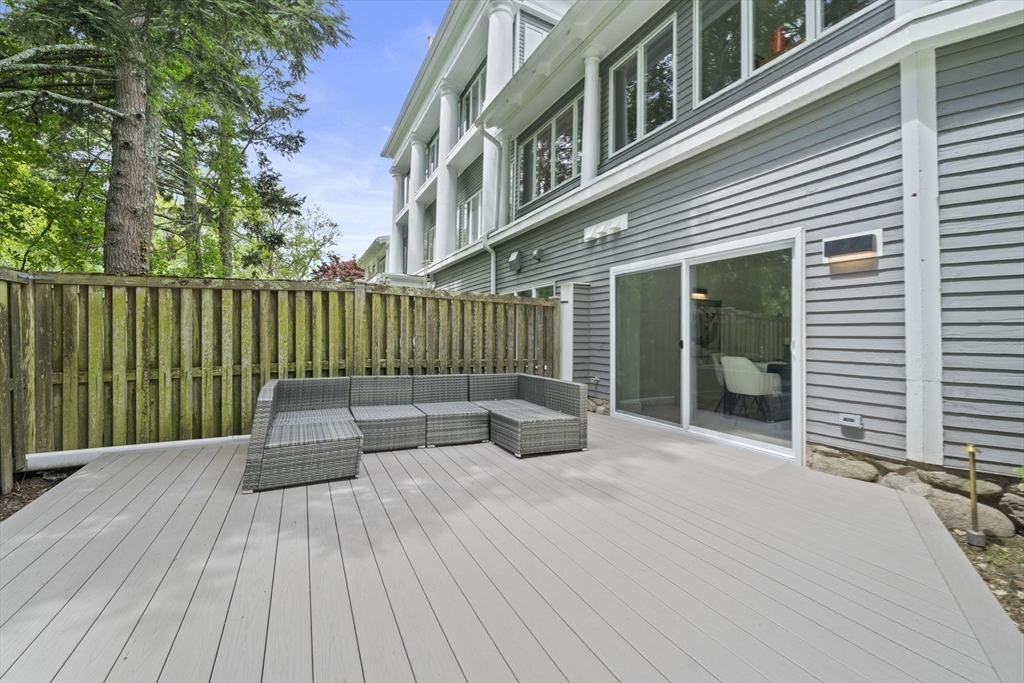 44 Ober Road, Unit 44 Newton, MA 02459 - Photo 38 of 41 a view of a deck with couches wooden floor and fence