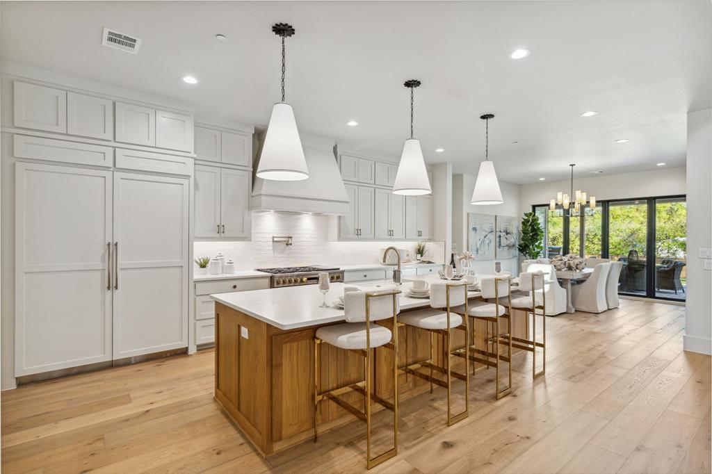 1405 Chelsea Rae Lane Keller, TX 76262 - Photo 11 of 35 a large kitchen with lots of counter space a sink appliances and a living room view