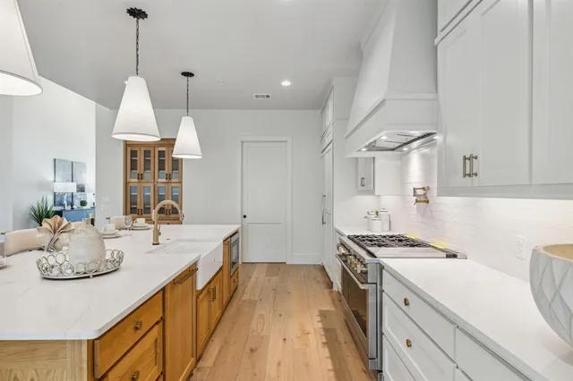 a kitchen with sink stove and cabinets