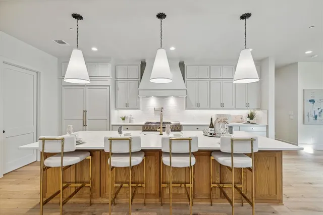 a dining room with furniture a chandelier and wooden floor