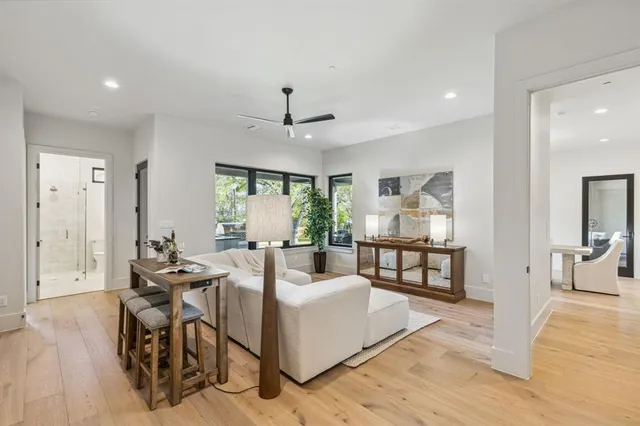 a living room with furniture and wooden floor