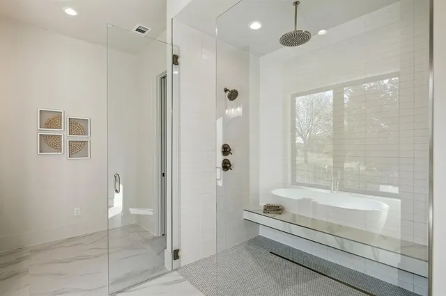 a bathroom with a bathtub and a shower