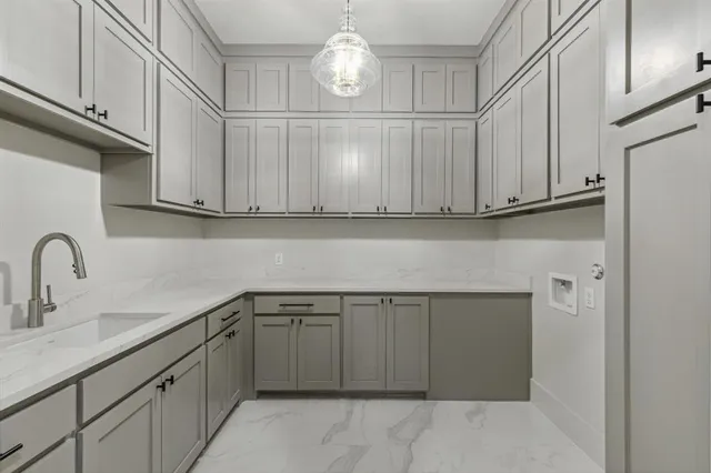 a kitchen with cabinets appliances and a sink