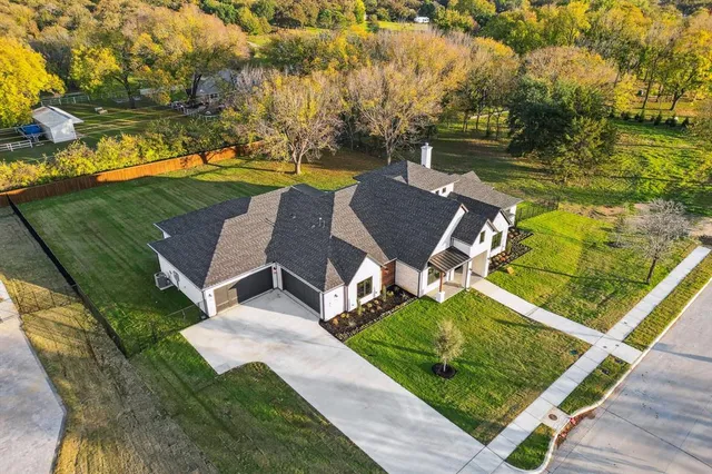 an aerial view of a house with garden space and street view