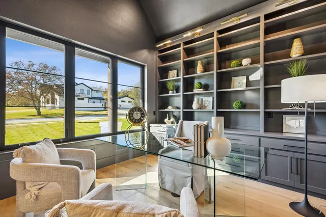 a living room with furniture a rug and a large window