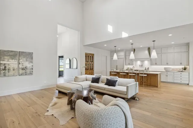 a living room with furniture and kitchen view