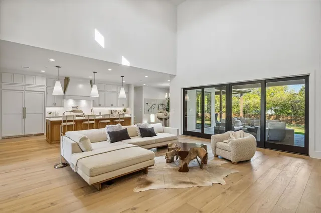 a living room with furniture and large windows