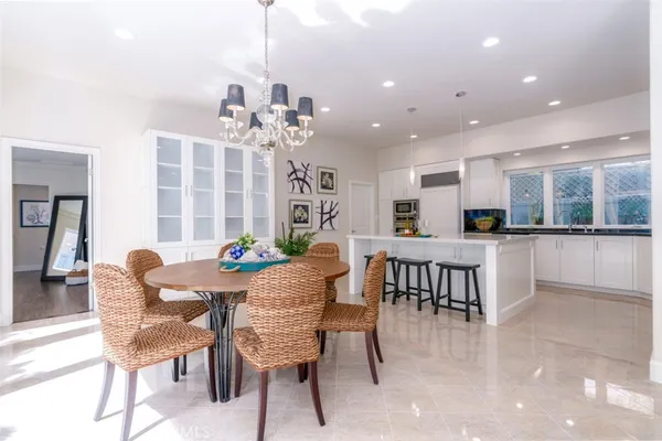 a view of a dining room with furniture and chandelier