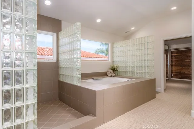 a spacious bedroom with a bed and a couch