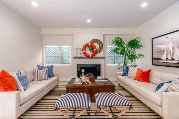 a living room with furniture a rug and a fireplace