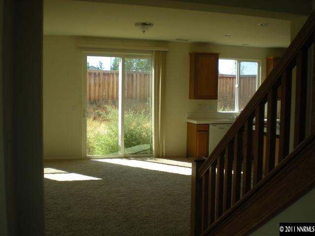 480 Stradella Court Reno, NV 89521 - Photo 3 of 13 a view of an empty room with wooden floor and a window