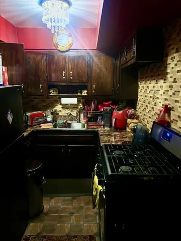 a kitchen with a stove and a refrigerator