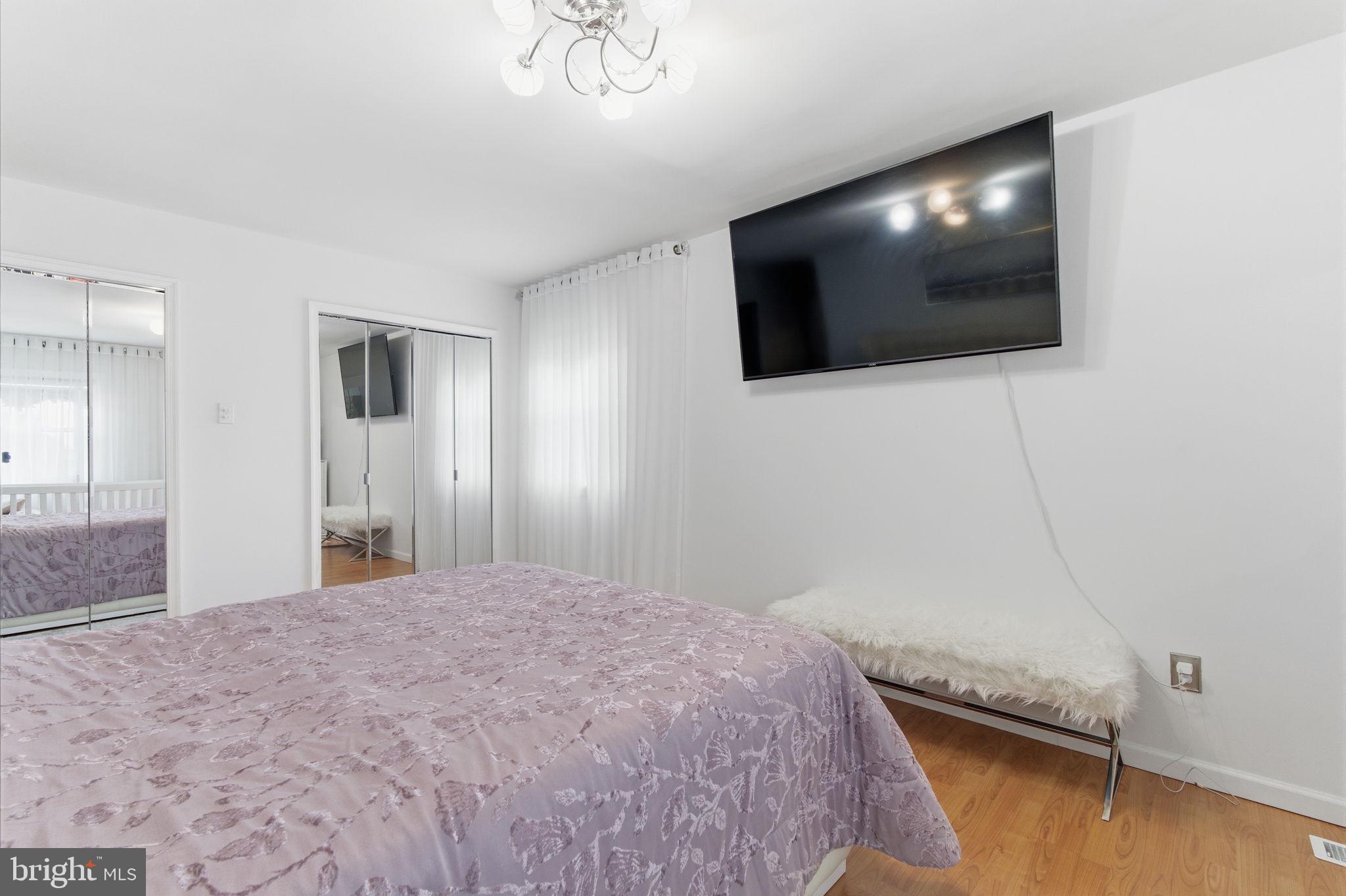 148 Rennard Street Philadelphia, PA 19116 - Photo 19 of 31 a bedroom with a bed and a flat screen tv