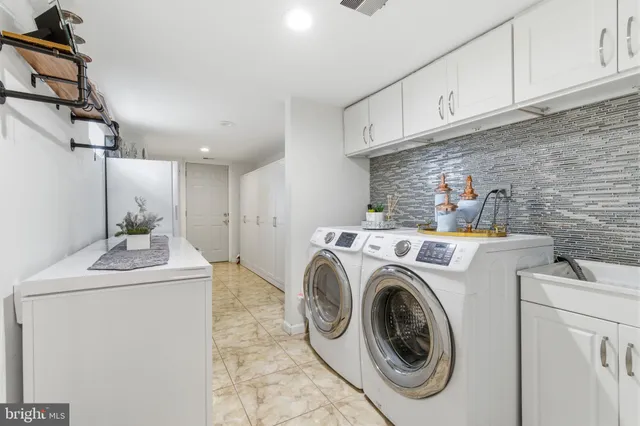 a kitchen with cabinets and wooden floor