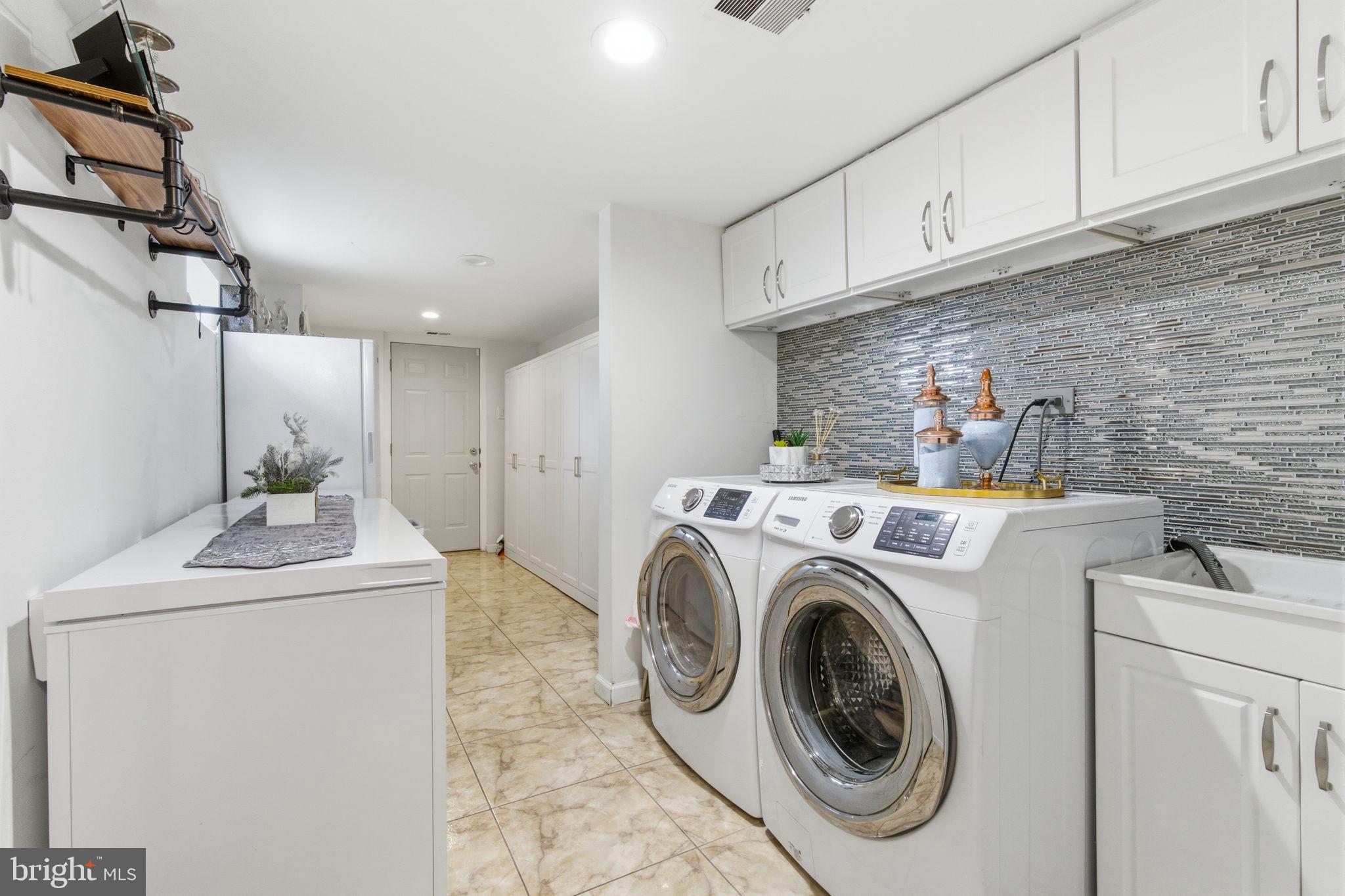 148 Rennard Street Philadelphia, PA 19116 - Photo 22 of 31 a utility room with sink dryer and washer