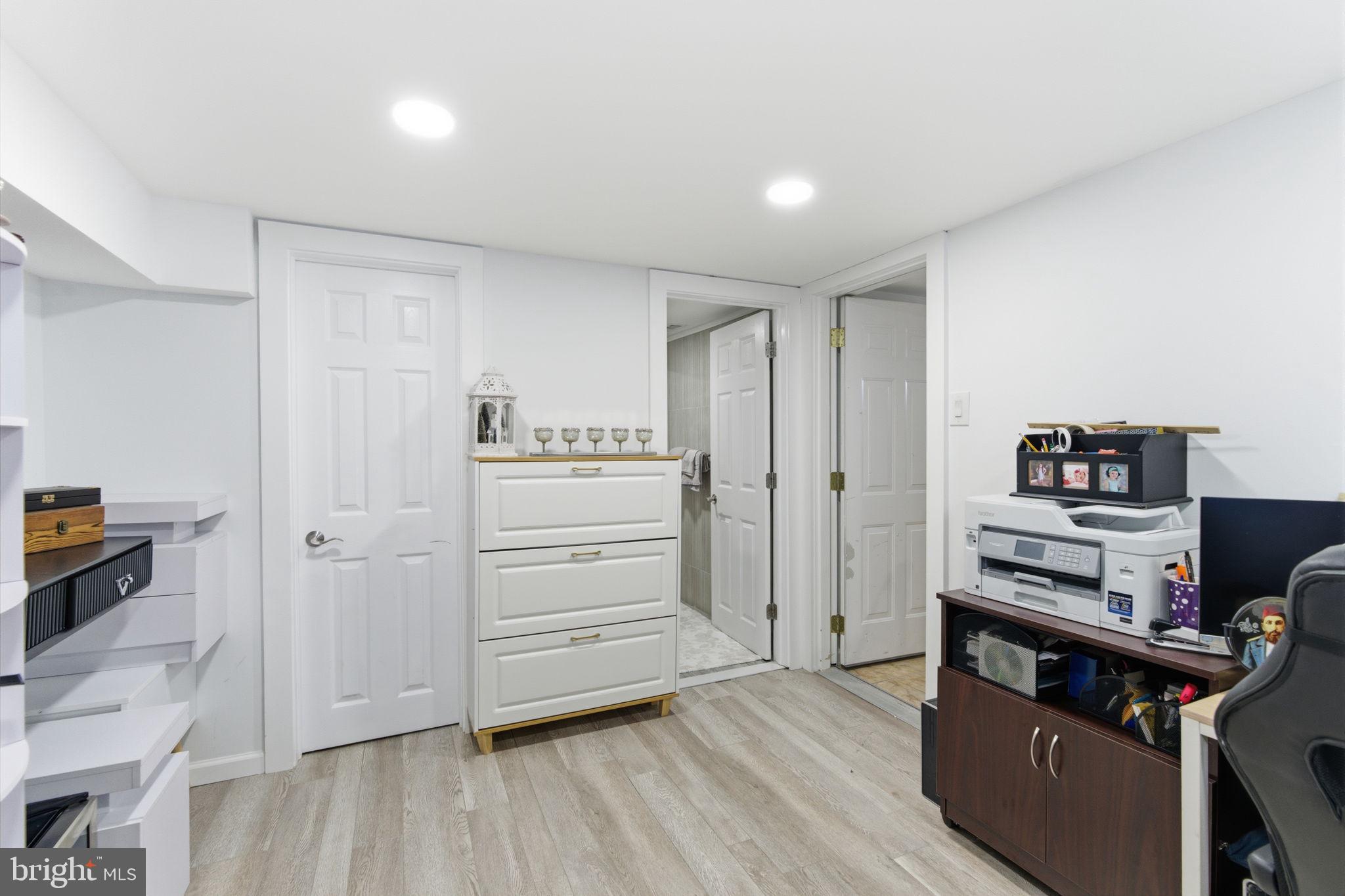 148 Rennard Street Philadelphia, PA 19116 - Photo 23 of 31 a kitchen with cabinets and wooden floor