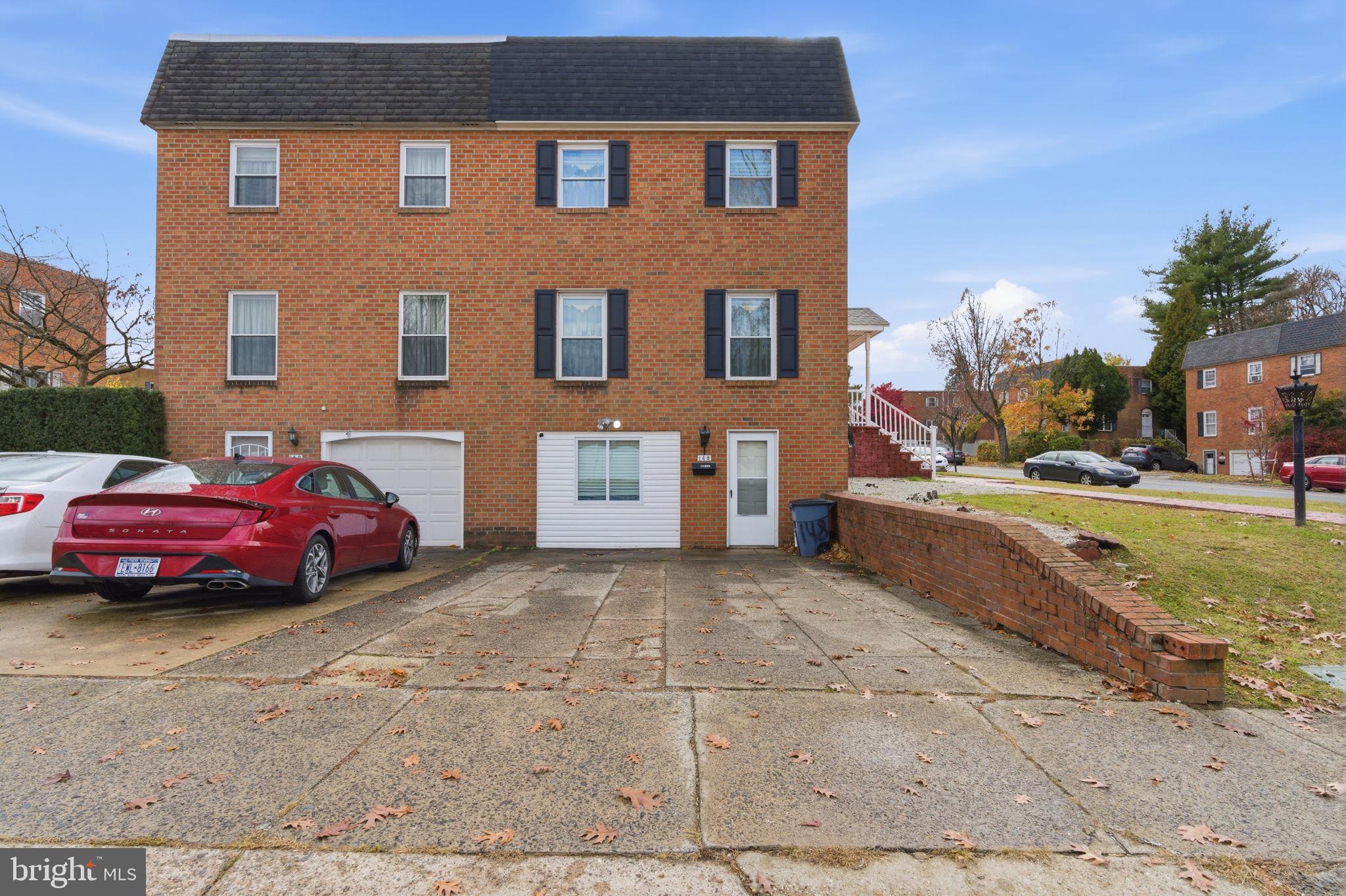 148 Rennard Street Philadelphia, PA 19116 - Photo 30 of 31 a view of a car parked in front of a brick house