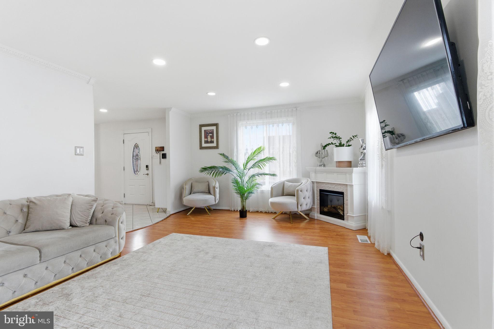 148 Rennard Street Philadelphia, PA 19116 - Photo 3 of 31 a living room with furniture and a fireplace