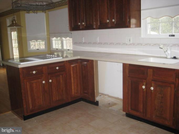 116 Sheaffer Road Chestertown, MD 21620 - Photo 5 of 21 a kitchen with sink and cabinets