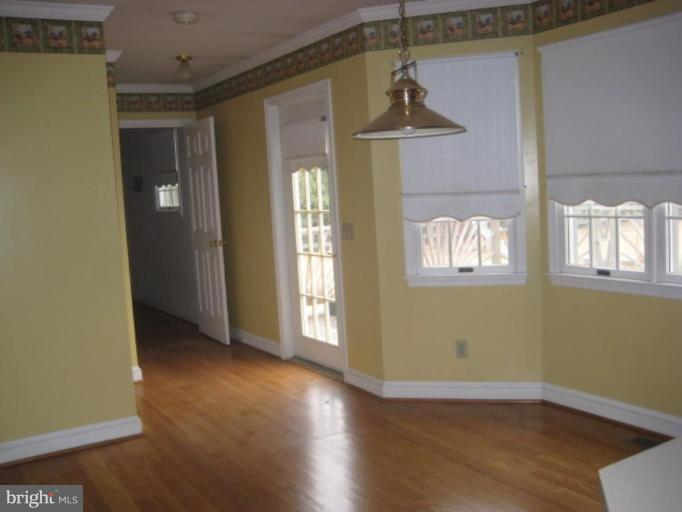 116 Sheaffer Road Chestertown, MD 21620 - Photo 7 of 21 an empty room with wooden floor and windows