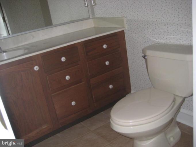 116 Sheaffer Road Chestertown, MD 21620 - Photo 8 of 21 a white toilet sitting next to a bathroom sink and vanity