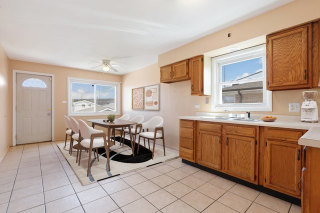 14929 Cleveland Avenue Posen, IL 60469 - Photo 9 of 21 a open kitchen with stainless steel appliances granite countertop a sink table and chairs