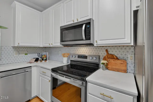 a kitchen with microwave cabinets and stove top oven