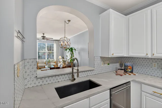 a kitchen with stainless steel appliances granite countertop a sink and cabinets with wooden floor