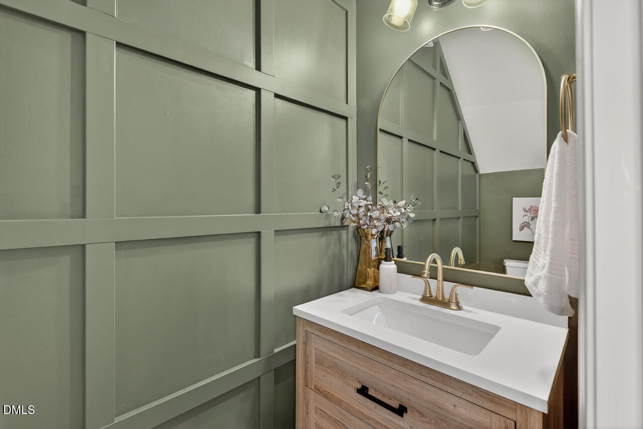 3811 Ramblewood Avenue Durham, NC 27713 - Photo 16 of 27 a bathroom with a sink and a mirror