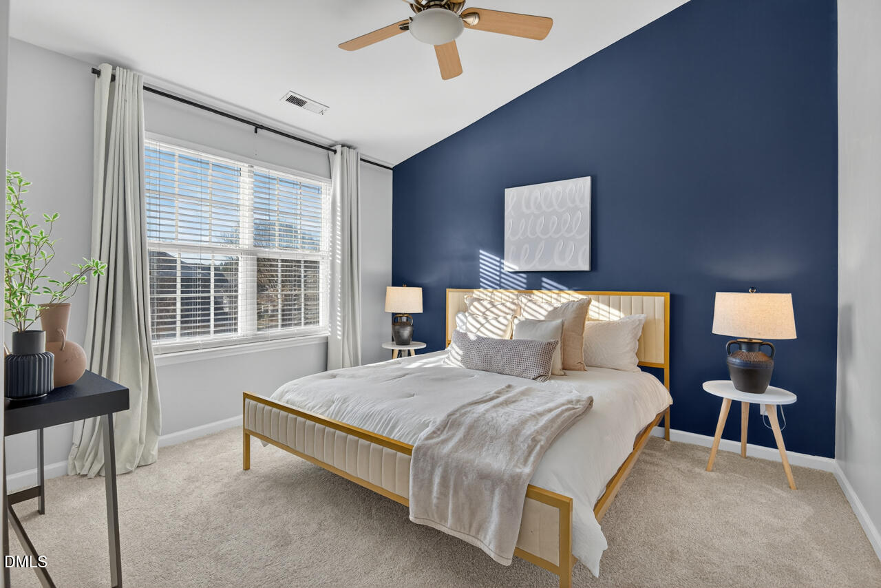 3811 Ramblewood Avenue Durham, NC 27713 - Photo 17 of 27 a bedroom with a bed and a chandelier