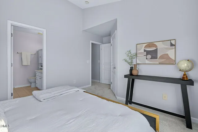 a bedroom with a bed and a mirror