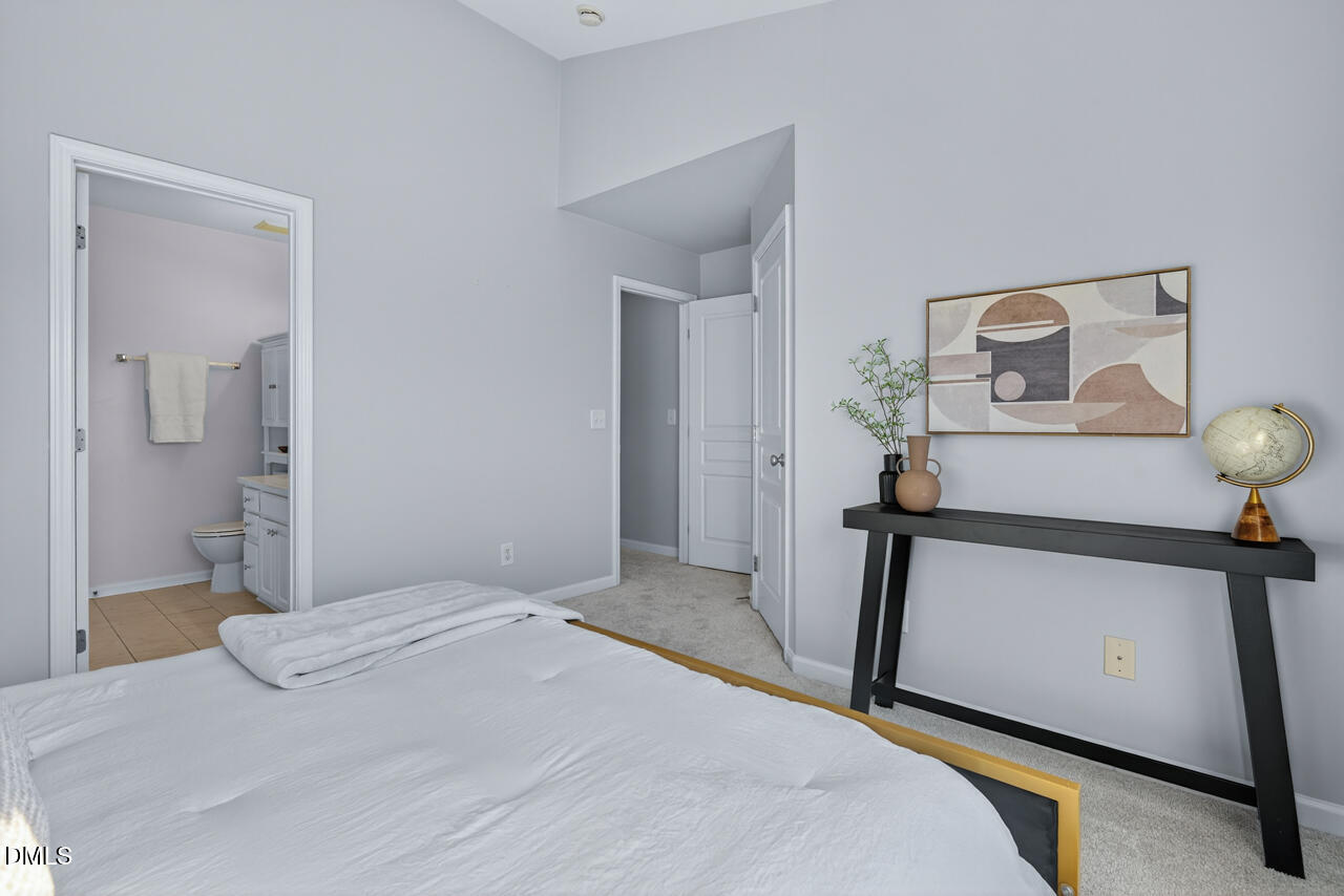 3811 Ramblewood Avenue Durham, NC 27713 - Photo 19 of 27 a bedroom with a bed and a mirror