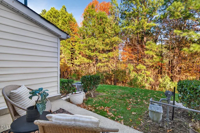 a view of a chair and table in backyard