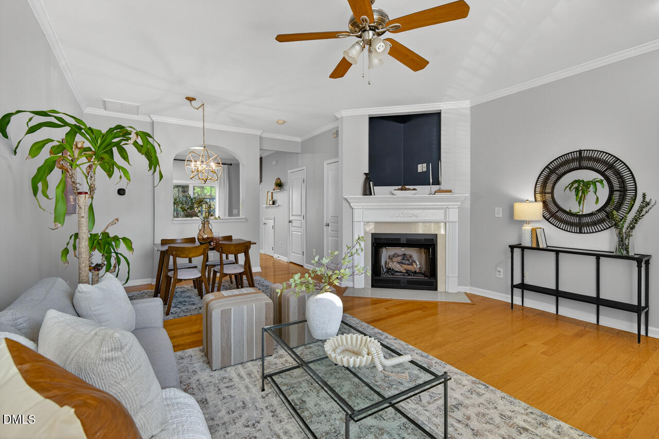 3811 Ramblewood Avenue Durham, NC 27713 - Photo 6 of 27 a living room with furniture a flat screen tv and a fireplace