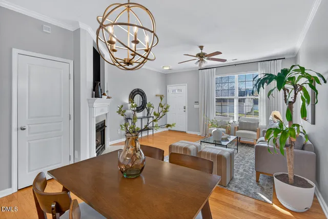 a view of a dining room with furniture a chandelier and wooden floor